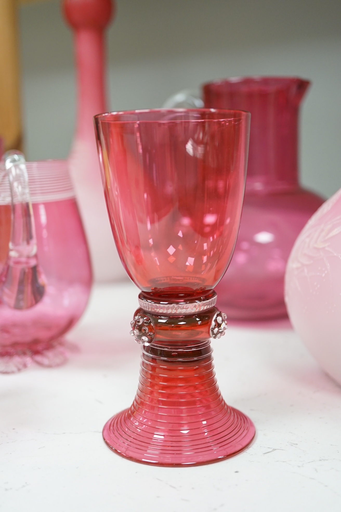 A pair of Victorian pink satin long necked vases, 25cm high, and five pieces of cranberry coloured glassware, (8). Condition - fair to good.